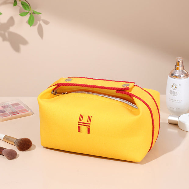 Stylish yellow canvas makeup bag from eprolo, showcasing its compact design and zipper closure. Perfect for on-the-go storage of cosmetics and toiletries.