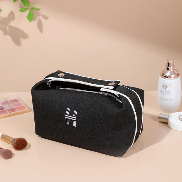 Sophisticated portable premium canvas makeup bag in black, designed by eprolo for optimal storage of cosmetics and toiletries.